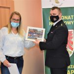 pani dyrektor Biblioteki Publicznej w Gołdapi Agnieszka Dziobkowska obok stoi zastępca komendanta Państwowej Straży Pożarnej oboje trzymają puzzle w ramach akcji „Cała Polska czyta dzieciom”