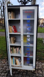 Otwarta w połowie szafa a w niej ustawione książki