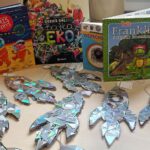 Fotografia przedstawia książki tematem nawiązujące do warsztatu oraz prace wykonane przez uczestników.